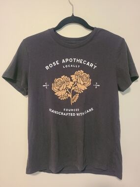 Schitts Creek Rose Apothecary Black Graphic Tee with Tan Rose Print